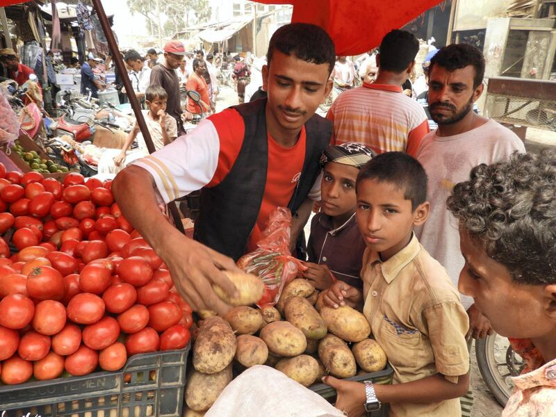 Children purchasing their daily needs in the public market amid the city of Al-Khoukhah. Ali Mahmood for The National