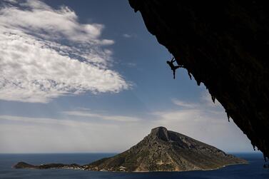 TOPSHOT - A climber participates in the 2019 annual Climbing Festival in the island of Kalymnos on October 4, 2019. The festival has attracted some 400 sports climbers from across the globe. The geography, the breathtaking views and the great weather conditions have made the Greek island of Kalymnos a top destination for international rock climbers of all levels with more than 2500 climbing routes. / AFP / ARIS MESSINIS