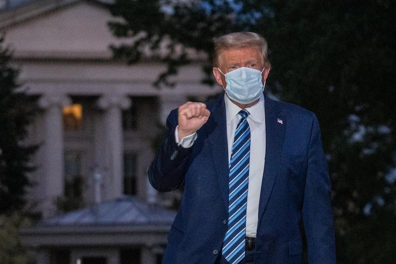US President Donald Trump gestures after returning to the White House, in Washington, DC, USA, following several days at Walter Reed National Military Medical Centre for treatment for Covid-19. EPA
