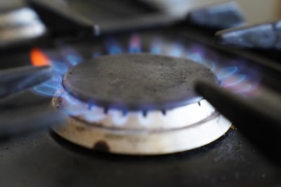 A gas hob burning on a stove. The lowering of the Ofgem cap will provide some relief to households, but still millions face energy poverty, according to charities.