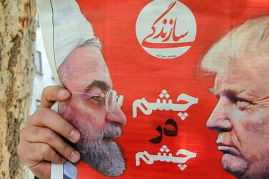 An Iranian man reads a newspaper with a pictures of Iranian president Hassan Rouhani and US President Donald Trump on its front page in Tehran, Iran, 9 April 2019. EPA