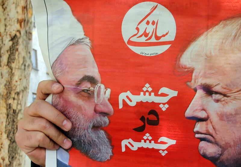 epaselect epa07493745 An Iranian man reads the Iranian daily newspaper 'Sazandegi' with a pictures of Iranian president Hassan Rouhani and US President Donald Trump on its front page and the title reading in Persian 'Eyes to Eyes',  next to a kiosk in Tehran, Iran, 09 April 2019. The US government on 08 April 2019 said it had designated Iran's revolutionary guards corps (IRGC) as a terrorist organization, marking the first time a US government has made such a designation on a foreign government's organization.  EPA/ABEDIN TAHERKENAREH