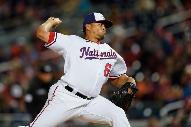 Washington Nationals relief pitcher Victor Arano throws a pitch to the New York Mets during the fifth inning of an opening day baseball game at Nationals Park in Washington. AP