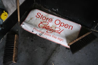 An 'open' sign sits on the ground outside of a closed store in New York as the coronavirus keeps many businesses closed. With much of the nation shut down to halt the spread of the novel coronavirus, the economy has taken its biggest hit since the Great Depression of the 1930s. AFP