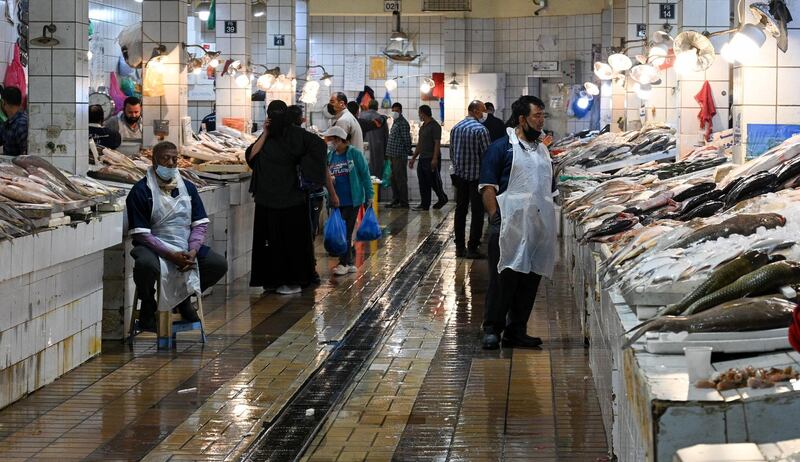 Staff and customers at the fish market in Kuwait City's Souk Al Mubarakiya.  EPA