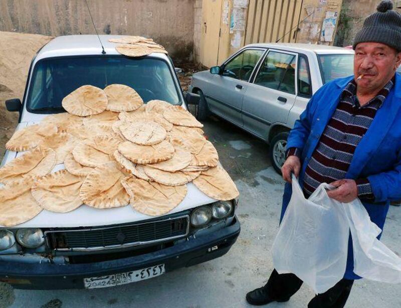 Bread is put out to cool in a working class neighbourhood in Damascus. Economic reforms have begun to hit the country's poor.
