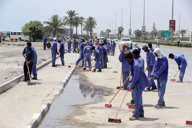 Municipality workers cleaning the road near the corniche after the recent flood in Fujairah. 