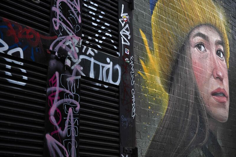 A piece of street art entitled 'Girl in a Ukrainian hat' by WOSKerski on a wall in London. AFP