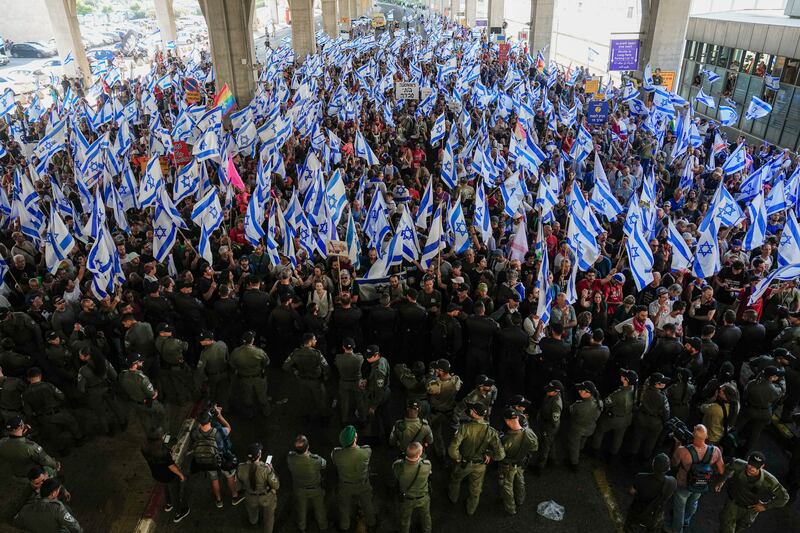 Israelis wave flags during a protest against plans by Prime Minister Benjamin Netanyahu's government to overhaul the judicial system. AP