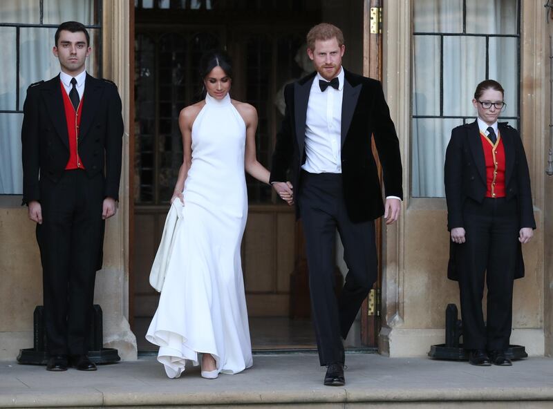 WINDSOR, UNITED KINGDOM - MAY 19: Duchess of Sussex and Prince Harry, Duke of Sussex leave Windsor Castle after their wedding to attend an evening reception at Frogmore House, hosted by the Prince of Wales on May 19, 2018 in Windsor, England. (Photo by Steve Parsons - WPA Pool/Getty Images)