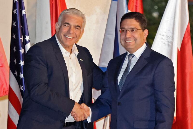 Mr Lapid, left, greets Morocco’s Foreign Minister Nasser Bourita on his arrival at Sde Boker.  AFP