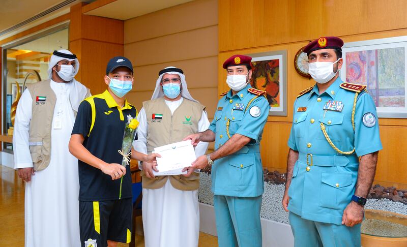 Sharjah Police officers and charity workers with one of the 12 men who was lured to the UAE. Each was given a flight ticket to go home. Photo: Sharjah Police