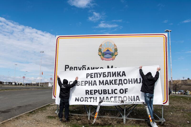 Signs are changed at the border between Macedonia and Greece near Gevgelija on February 13, 2019, to read North Macedonia after objections from Athens because Greece has a northern province of the same name. AFP