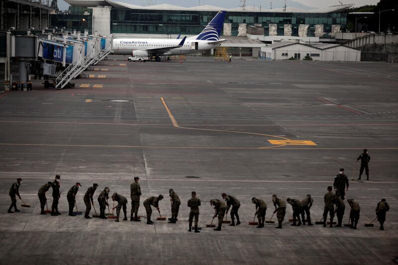Soldiers sweep the ash covered tarmac at La Aurora International Airport after Fuego volcano erupted violently, in Guatemala City, Guatemala. Luis Vargas / Reuters