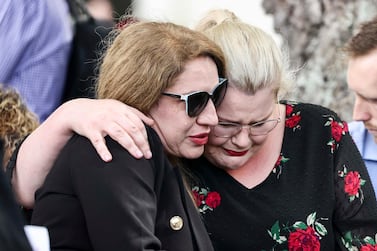 Two women embrace at the 10th anniversary memorial service of the Christchurch earthquake in Christchurch, New Zealand, on February 22, 2021. The 2011 earthquake killed 185 people. NZ Herald via AP