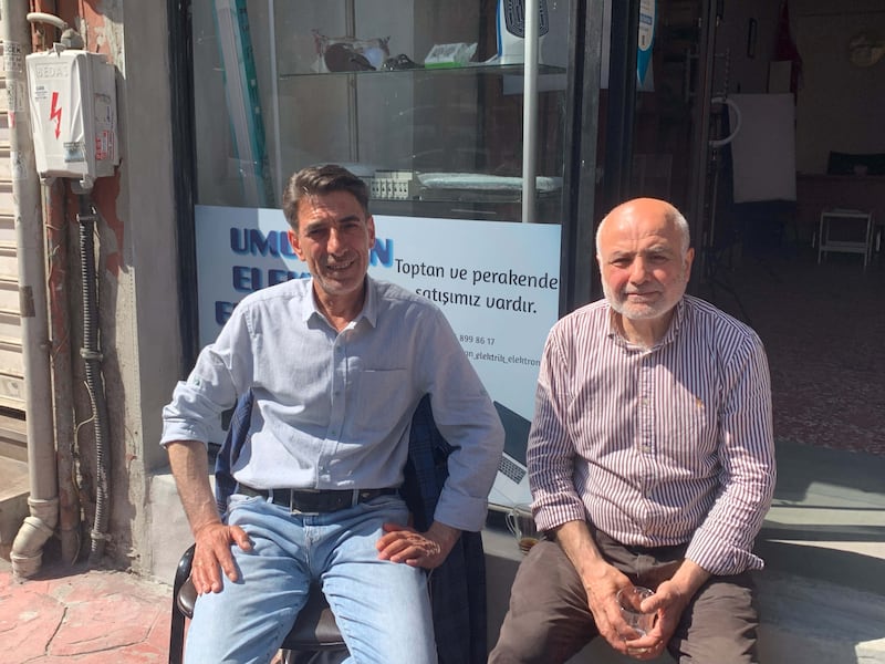 Nasip Kaplan, left, and Cevat Aydogan own shops on opposite sides of the road in Istanbul's Tarlabasi neighbourhood and have different views on who should be Turkey's next president. Jamie Prentis / The National