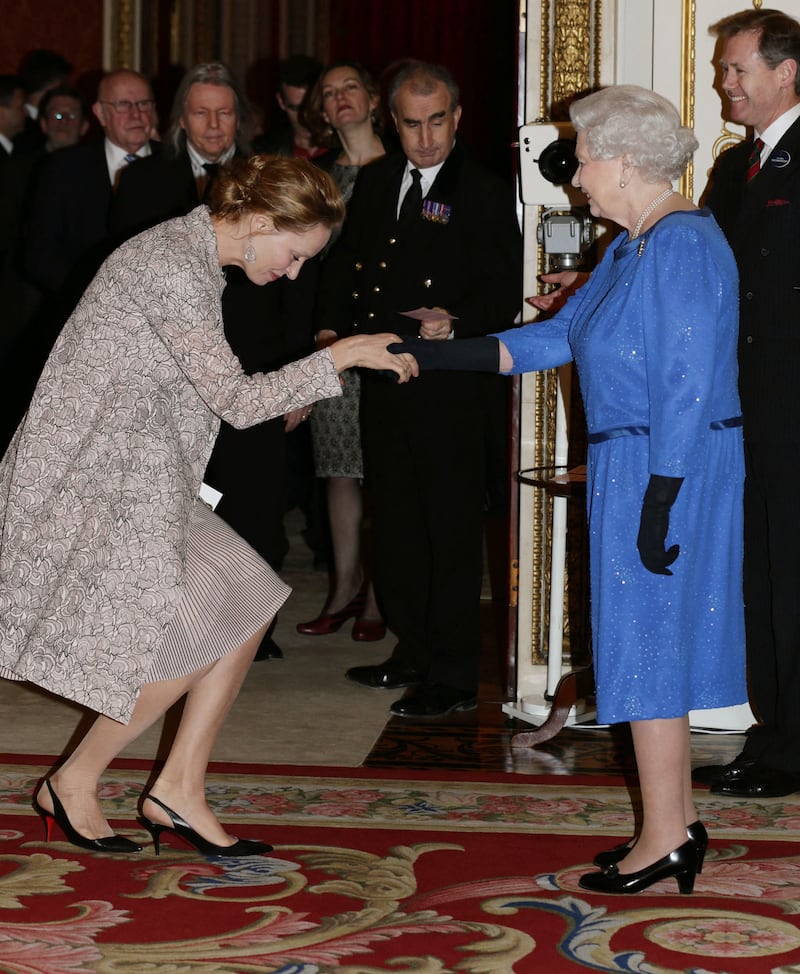 Queen Elizabeth II with US actress Uma Thurman during a Reception for the Dramatic Arts at Buckingham Palace in London, on February 17, 2014. AFP