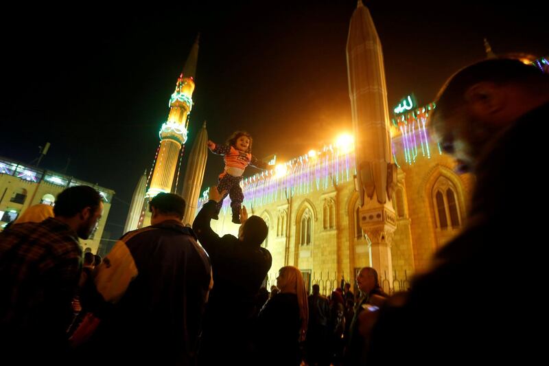 An Egyptian Sufi Muslim plays with his daughter during celebrate 'Mawlid al-Nabawi' or the birth of Prophet Mohammad outside the Al-Hussein mosque in old Cairo, Egypt. Amr Abdallah Dalsh / Reuters