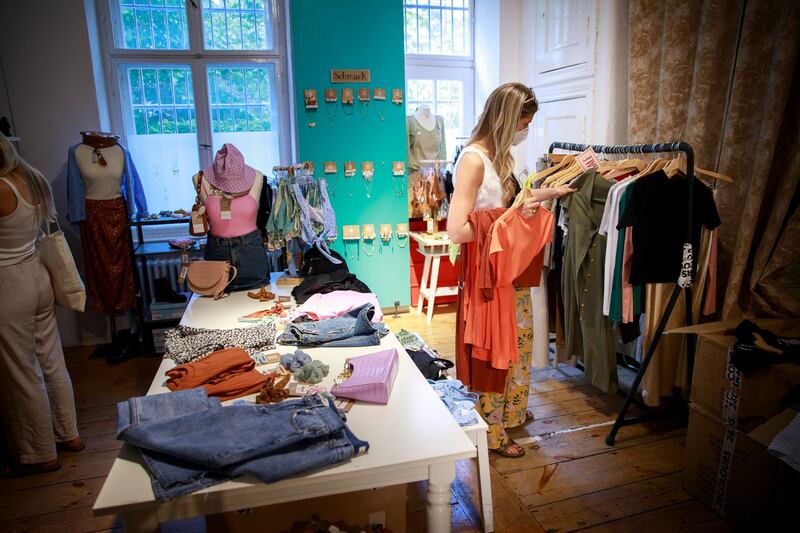 A shopper looks around a clothes store in Berlin, Germany. People are no longer required to show a negative Covid-19 test result to enter non-essential shops in Berlin. Getty Images