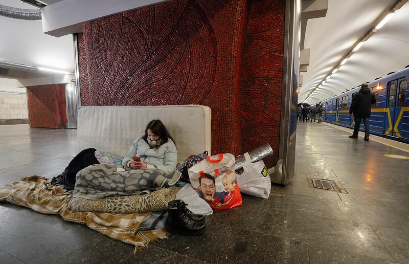 A Ukrainian woman takes shelter in a metro station during the day in Kyiv. EPA