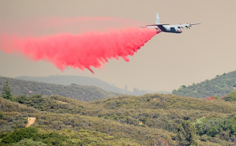 An air tanker drops retardant on a hillside ahead of the Mendocino Complex fire near Finley, California. AFP PHOTO / JOSH EDELSON