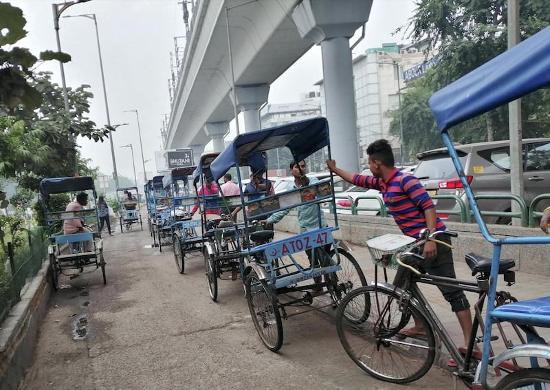 Rickshaw pullers wait for passengers outside a metro station in New Delhi as air quality continuous to remain in hazardous category. Taniya Dutta for The National 
