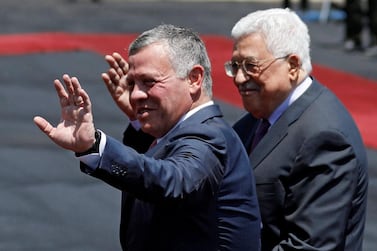 Jordan's King Abdullah II and Palestinian President Mahmoud Abbas wave during a reception ceremony in the West Bank city of Ramallah, August 7, 2017. REUTERS