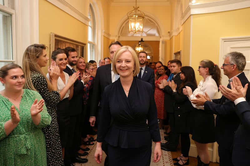 Ms Truss is welcomed by staff in Downing Street as she enters the famous prime ministerial offices for the first time. Andrew Parsons / No 10 Downing Street