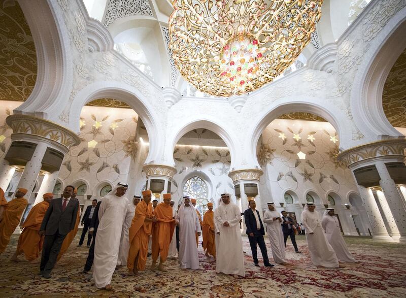 Mahant Swami Maharaj is guided through the prayer hall of the Grand Mosque by Sheikh Nahyan and Dr Yousif Alobaidli.