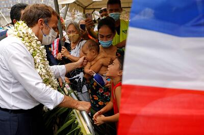 French President Emmanuel Macron greets locals outside the Criobe environmental research institute, in French Polynesia. AFP