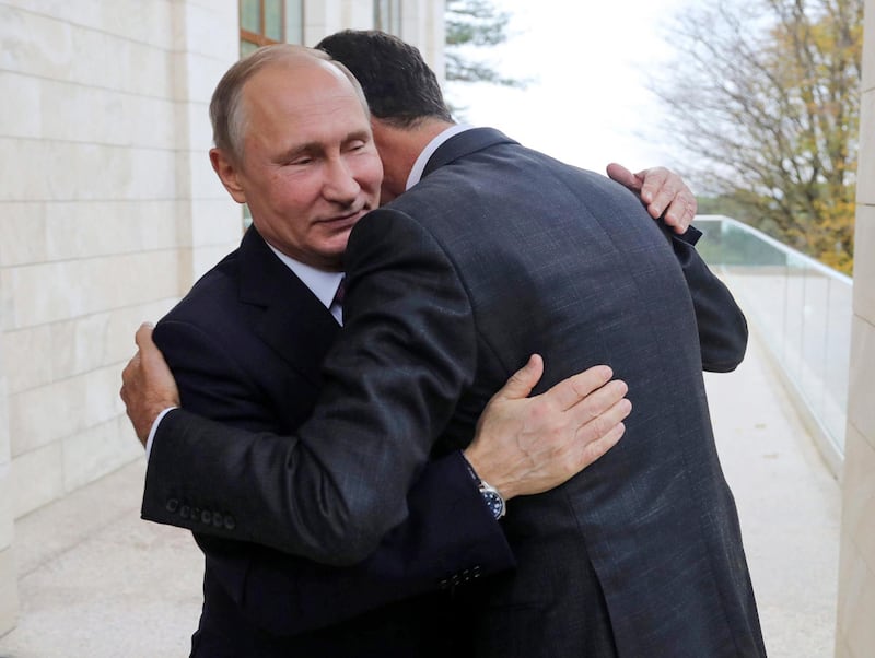 In this Monday, Nov. 20, 2017, photo, Russian President Vladimir Putin, left, hugs with Syrian President Bashar Assad in the Bocharov Ruchei residence in the Black Sea resort of Sochi, Russia. Putin has met with Assad ahead of a summit between Russia, Turkey and Iran and a new round of Syria peace talks in Geneva, Russian and Syrian state media reported Tuesday. (Mikhail Klimentyev, Kremlin Pool Photo via AP)