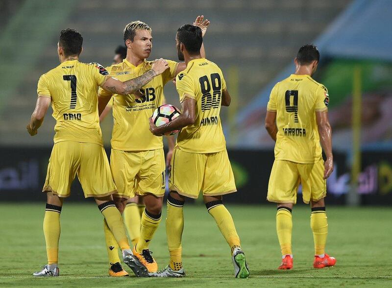 Fabio de Lima, second left, celebrates after scoring Al Wasl's equalising goal against Al Dhafra. Tom Dulat / Getty Images