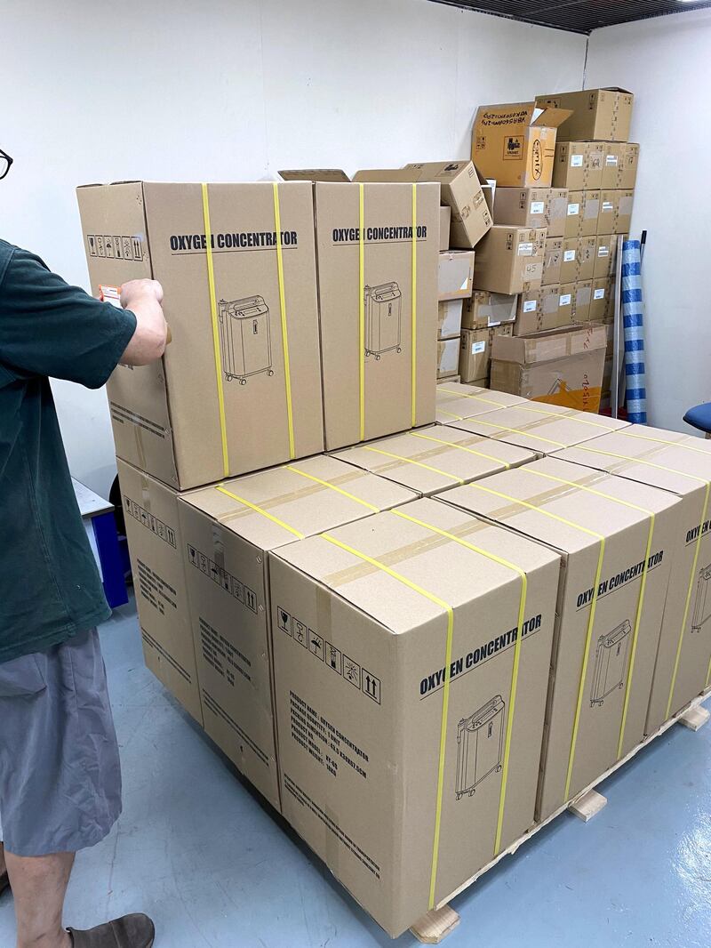 A worker packs oxygen concentrators, a device that extracts oxygen from the air to help Covid-19 patients breathe, in a warehouse in Hong Kong. Shipments of the machines to India has risen as people are forced to rely on home care of patients with hospitals turning away patients. courtesy Jacky’s Electronics