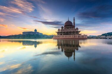 Masjid Putra, on the edge of Putrajaya Lake, is more traditional in style. Getty