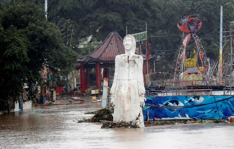 A statue is seen submerged along a flooded street next to a river bank, after continuous monsoon rains in Marikina, Metro Manila. Reuters