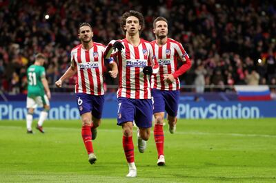 epa08063537 Atletico Madrid's Joao Felix (C) celebrates after converting a penalty during the UEFA Champions League group stage soccer match between Atletico Madrid and FC Lokomotiv Moscow at the Wanda Metropolitano stadium in Madrid, Spain, 11 December 2019.  EPA/JUANJO MARTIN