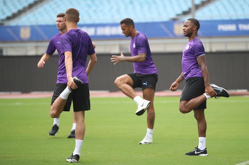 Raheem Sterling, right, stretches during training. Getty