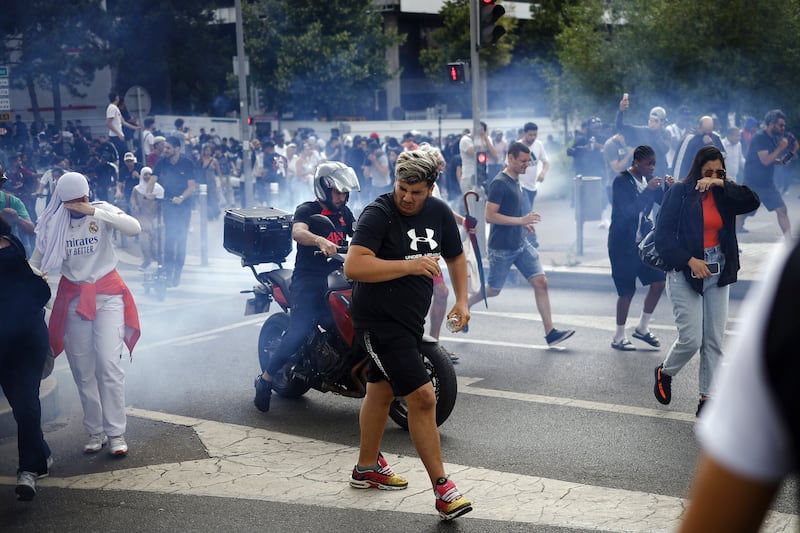 People flee tear gas fired by police during clashes with protesters at the march. EPA