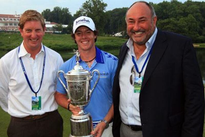 Rory McIlroy of Northern Ireland, standing with Stuart Cage, left, and his then agent Andrew 'Chubby' Chandler after winning the US Open. McIlroy fired Chandler recently but wants to 'remain friends' with him.