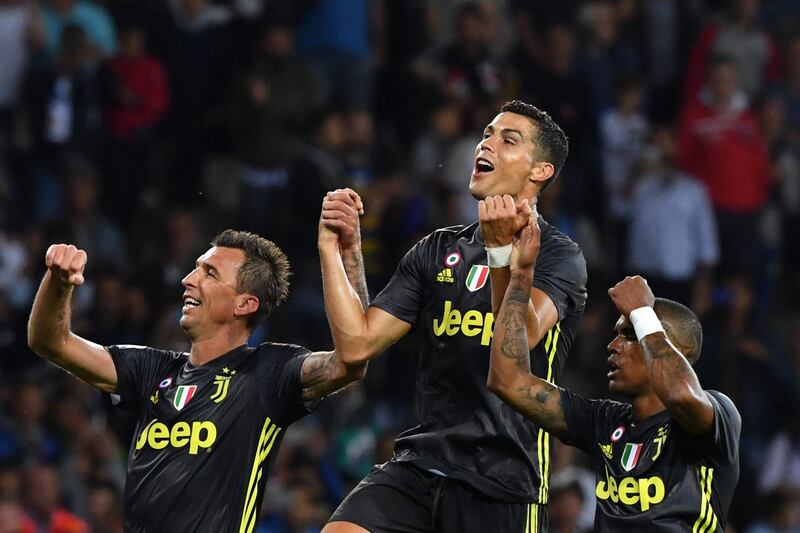 Mario Mandzukic, Cristiano Ronaldo and Douglas Costa celebrate Juventus' victory. AFP