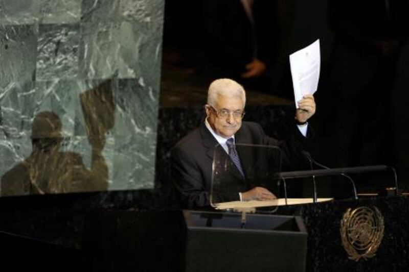 Mahmoud Abbas, President of the Palestinian Authority, shows a copy of the letter requesting Palestine's full admission to the UN as a sovereign state during the United Nations General Assembly on September 23, 2011 at UN headquarters in New York. The Palestinian leader won huge applause and a standing ovation Friday from some of the assembly as he entered the hall shortly after asking the UN to admit the state of Palestine.   AFP PHOTO / TIMOTHY A. CLARY
 *** Local Caption ***  899722-01-08.jpg