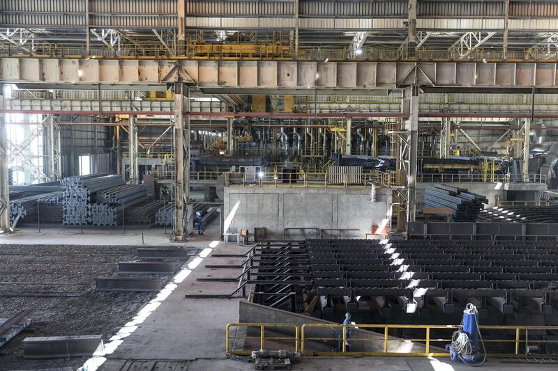 ABU DHABI, UNITED ARAB EMIRATES. 05 MARCH 2018. Site visit / press tour of the Emirates Steel plant in Mussafah. A crane moves finished steel bars to the cooling area. (Photo: Antonie Robertson/The National) Journalist: Sarmad Khan. Section: Business.