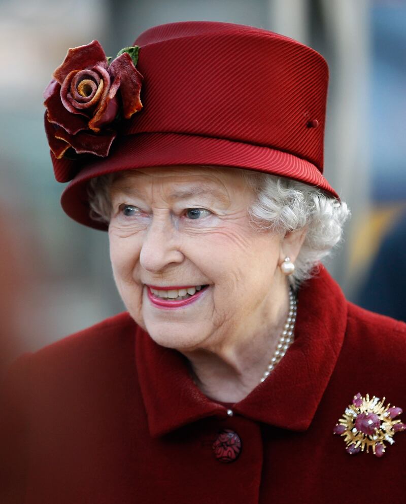 Queen Elizabeth II wears her Grima ruby brooch, which was a gift from the Duke of Edinburgh in 1966, during a visit to Liverpool in December 2011. Getty Images