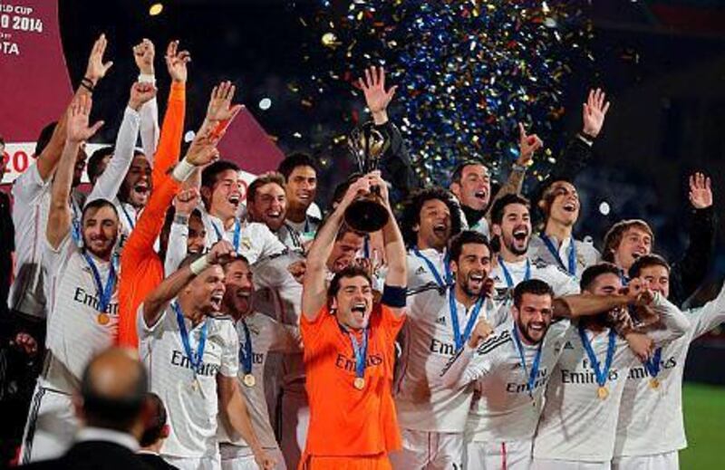 Real Madrid's captain Iker Casillas, centre, lifts the trophy as his teammates celebrate after their victory in the final final match of the Fifa Club World Cup 2014 between San Lorenzo of Argentina and Real Madrid of Spain, in Marrakech, Morocco, 20 December 2014. EPA/MOHAMED MESSARA