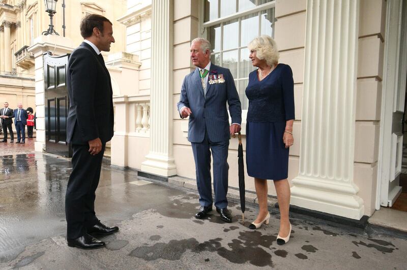 Prince Charles and Britain's Camilla, Duchess of Cornwall, right, greet French President Emmanuel Macron. AFP