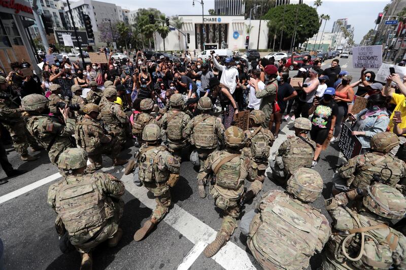Members of the National Guard take a knee as people protest against the death of George Floyd in Minneapolis police custody, in Hollywood, Califronia.  EPA