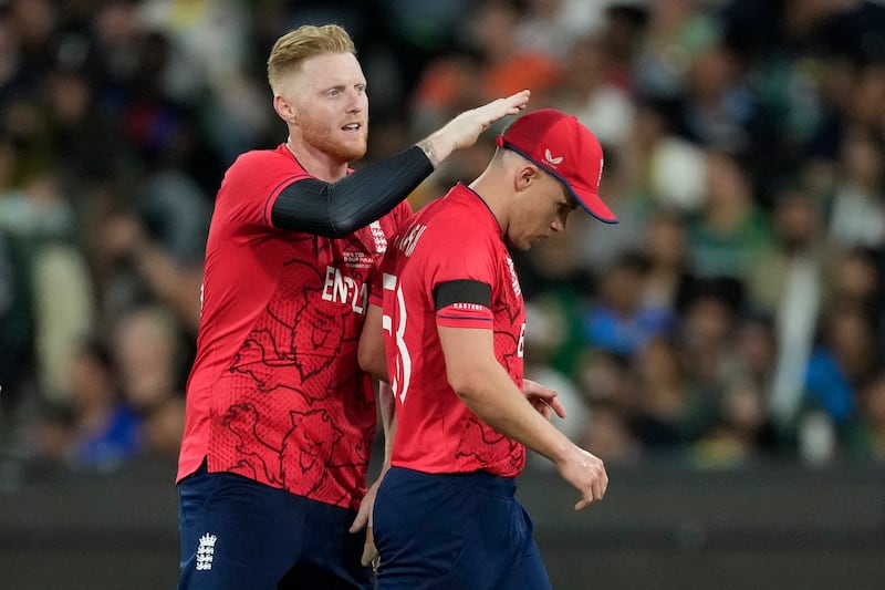 England's Ben Stokes congratulates teammate Sam Curran at the end of his bowling spell. AP 