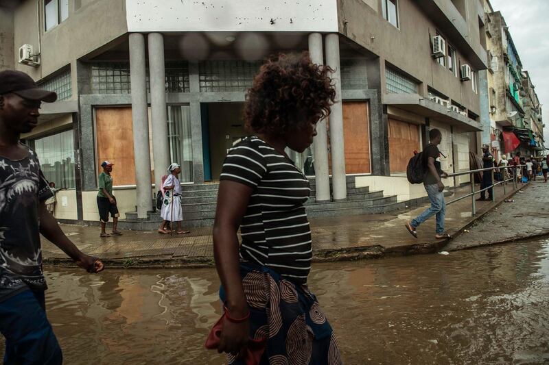 People walk in a flodded street in Beira. Getty Images