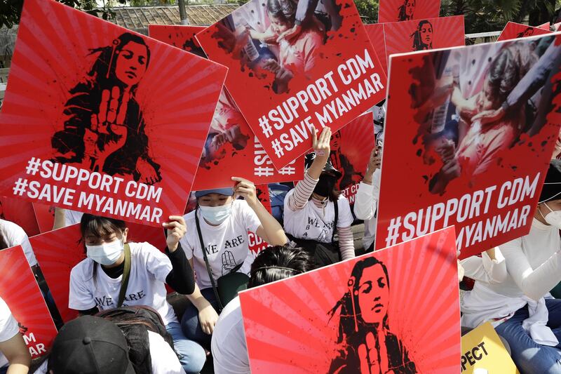 Demonstrators hold up placards supporting the CDM during a protest outside the Central Bank in Yangon, Myanmar. EPA