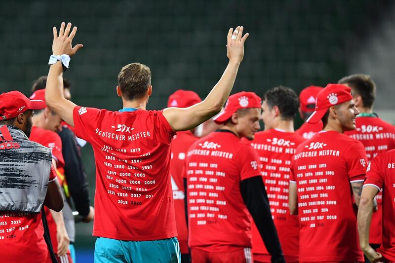 Manuel Neuer (front) celebrates securing the Bundesliga title. EPA
